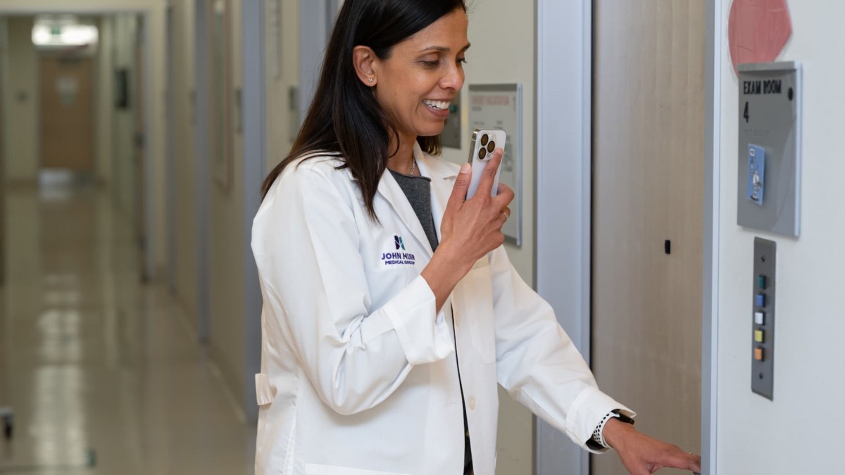 108150592-1748346884055-clinician-entering-an-exam-room20250528102804.jpg?rt=20250528102807